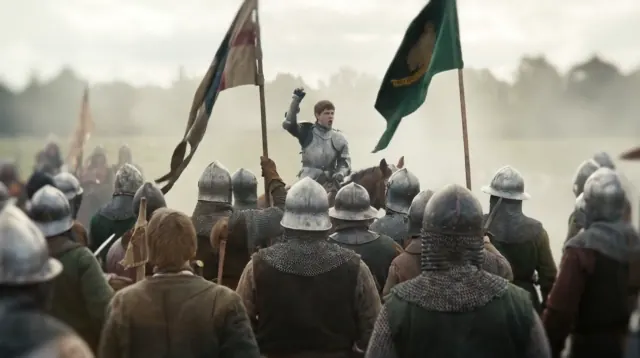 An armored commander faces a dense gathering of soldiers under tall battle flags in a pale misty landscape.