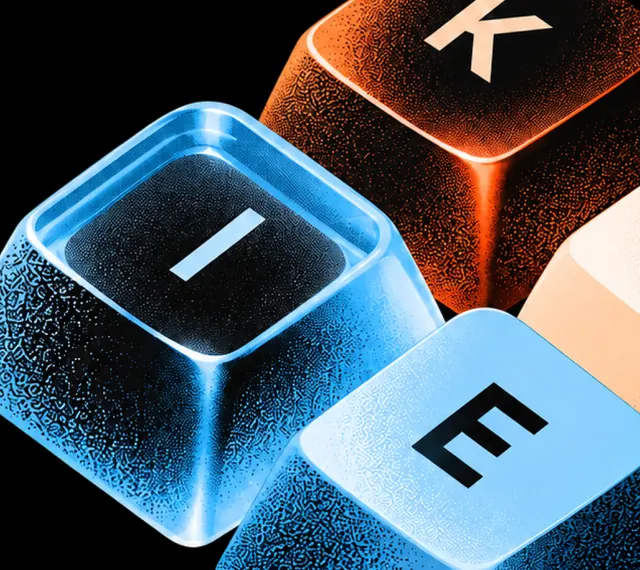 Cropped cyan and amber translucent keycaps with I K E lettering and etched grain on black