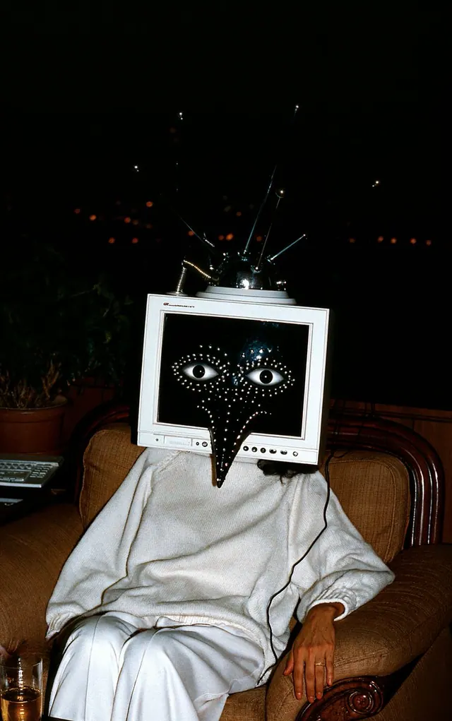 CRT Oracle in an Armchair. Visual study of surreal portrait, CRT monitor head, analog flash photography