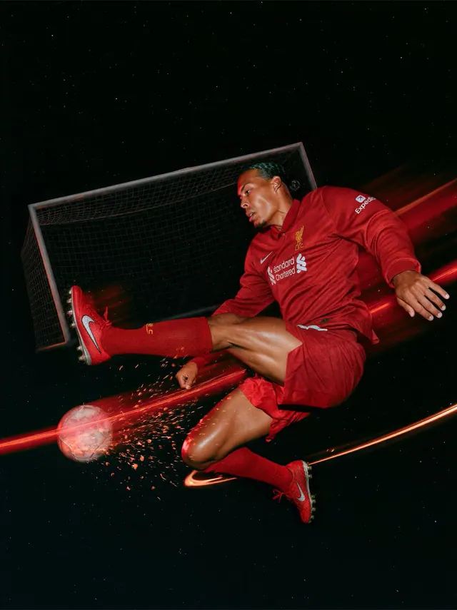 Red Football Kick Through Sparks. Visual study of football poster, red light trails, sports action